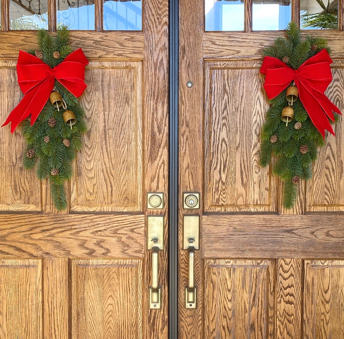 Christmas Door Swag Classic - Real Touch Pine with 2 Brass Bells, Sequoia Pine Cones and red Velvet Bow