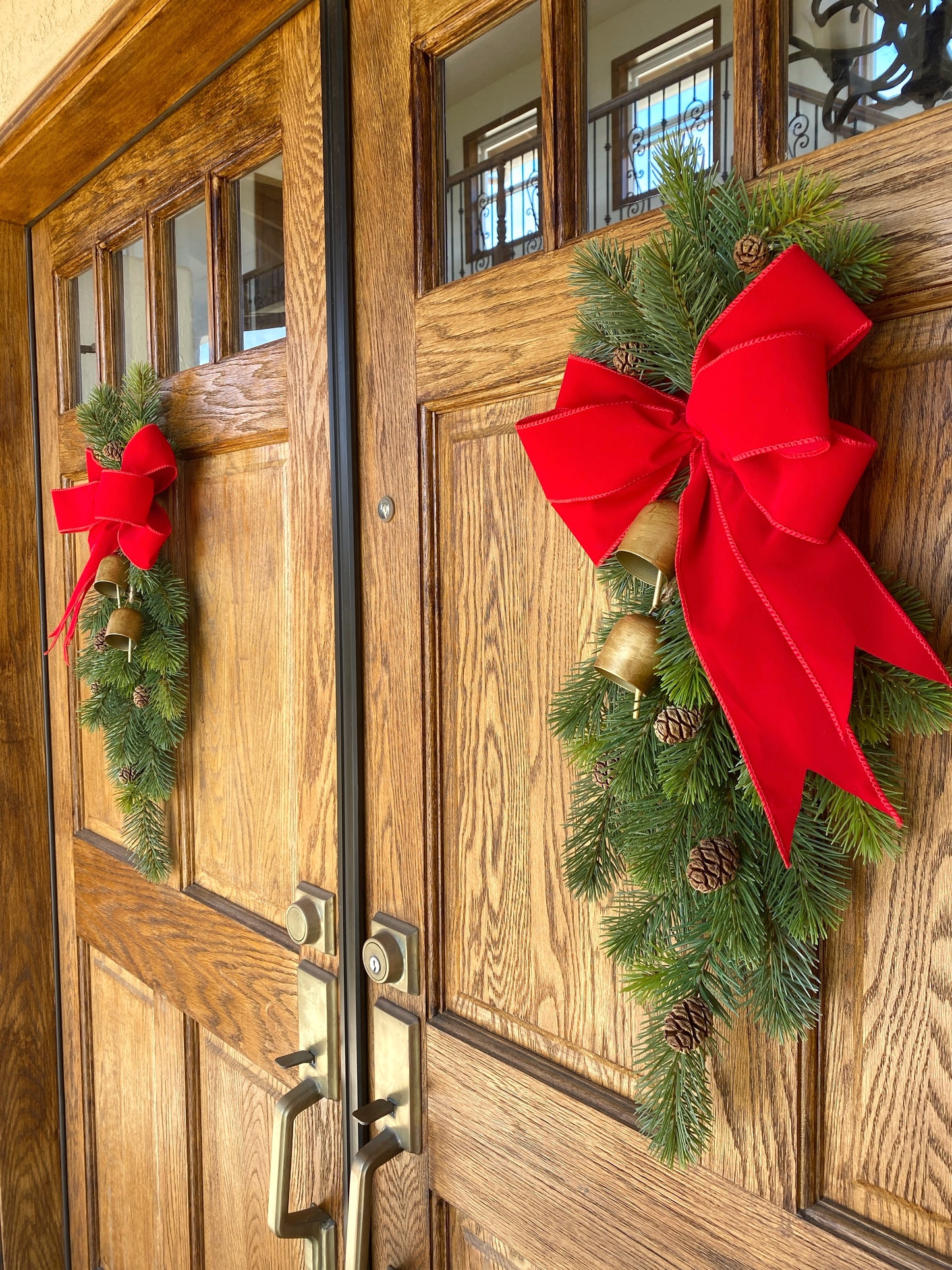 Christmas Door Swag Classic - Real Touch Pine with 2 Brass Bells, Sequoia Pine Cones and red Velvet Bow