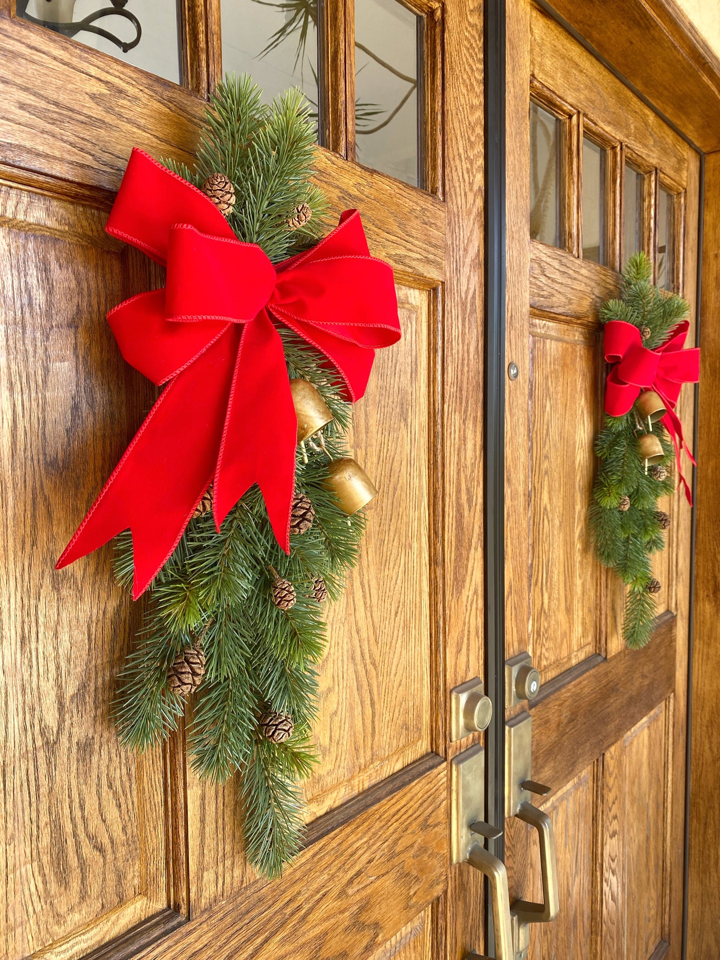 Christmas Door Swag Classic - Real Touch Pine with 2 Brass Bells, Sequoia Pine Cones and red Velvet Bow