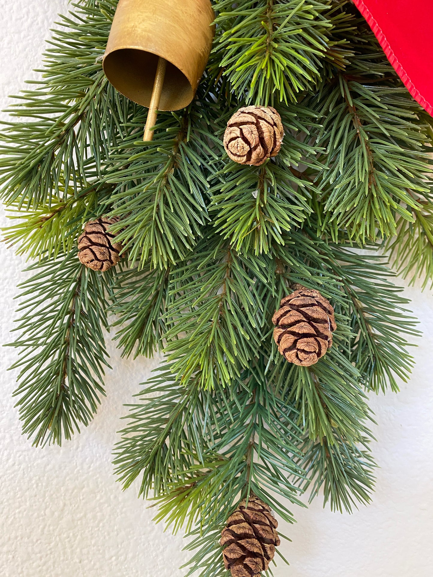 Christmas Door Swag Classic - Real Touch Pine with 2 Brass Bells, Sequoia Pine Cones and red Velvet Bow