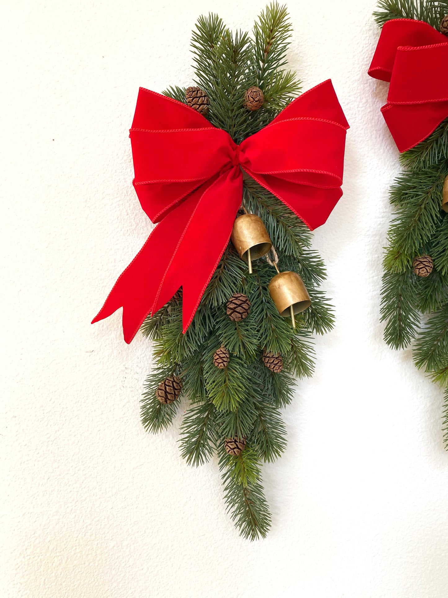 Christmas Door Swag Classic - Real Touch Pine with 2 Brass Bells, Sequoia Pine Cones and red Velvet Bow